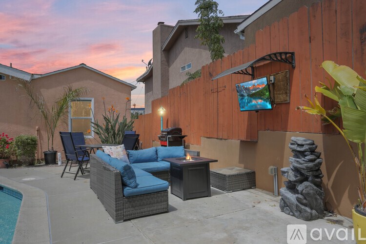 A backyard with a pool and a couch.