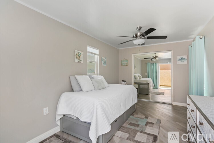 A bedroom with a bed, dresser, and mirror.