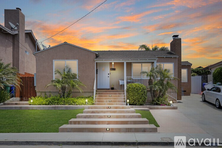 A house with a front yard and a car parked in front.