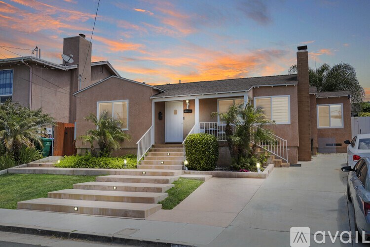 A house with a car parked in front of it.