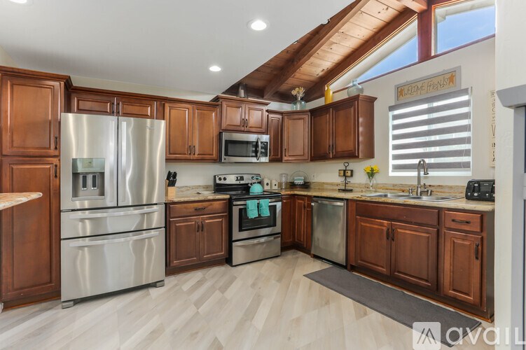 A kitchen with wooden cabinets and stainless steel appliances.