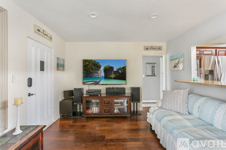 A living room with a television and a couch.