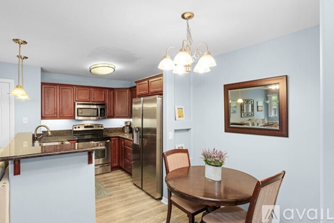 A kitchen with a table and chairs in the middle of the room.