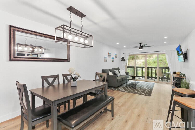 A modern dining room with a wooden table and chairs.