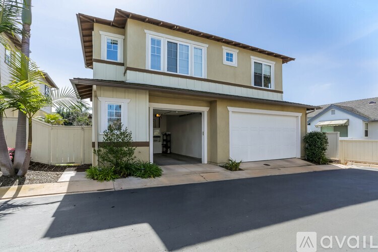A two-story house with a garage is available for sale.