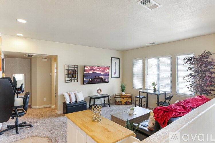 A living room with a couch, chair, and a television.