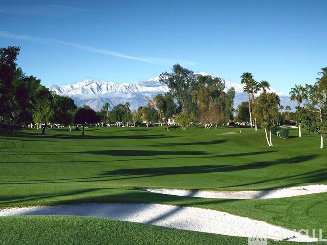 A golf course with a mountain in the background.