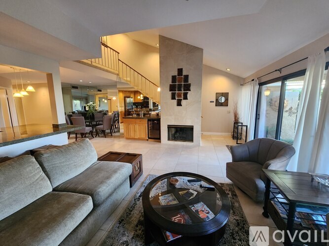 A living room with a grey couch and a coffee table.
