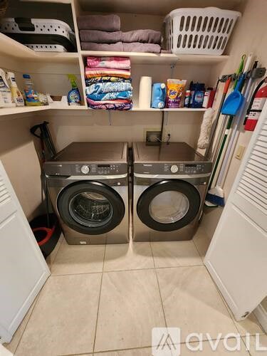 A small laundry room with two front loading washing machines.