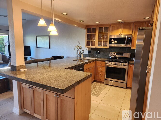 A kitchen with granite countertops and stainless steel appliances.