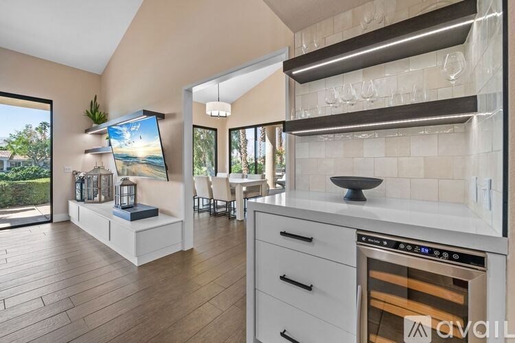 A modern kitchen with a stainless steel oven and wooden flooring.