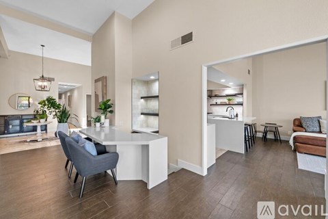 A modern living room with a grey sofa and a white coffee table.