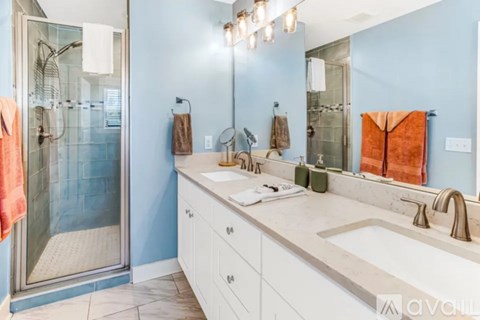 A bathroom with a blue wall and a white sink.