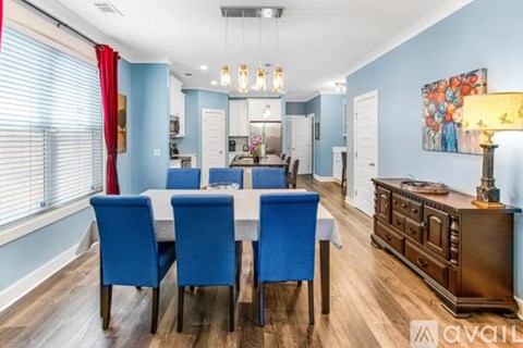 A dining room with a table set for four.
