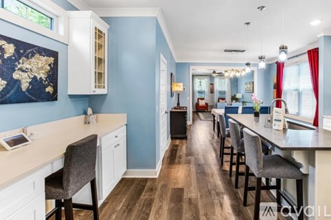 A kitchen with a blue wall and a world map on it.