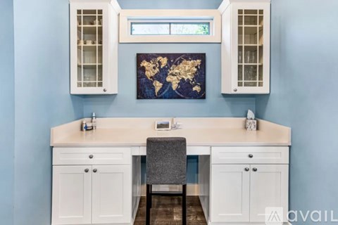 A kitchen with a world map on the wall.