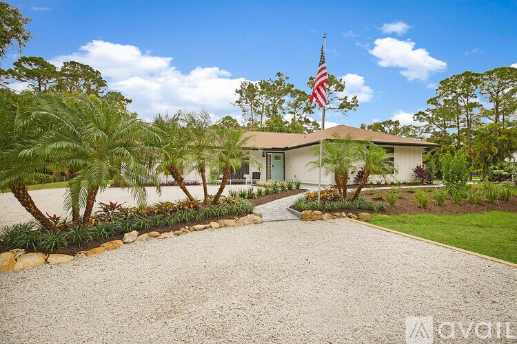 A house with a flag on the front lawn.
