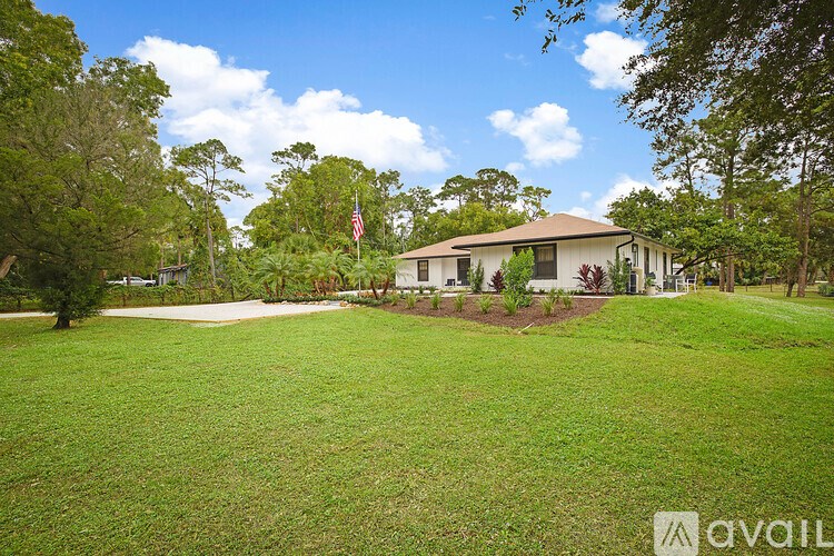 A house with a flag on the lawn.