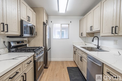A kitchen with wooden cabinets and stainless steel appliances.