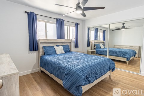 A bedroom with a large bed and a mirror on the wall.