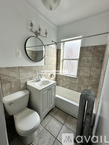 A bathroom with a toilet, sink, and tub.
