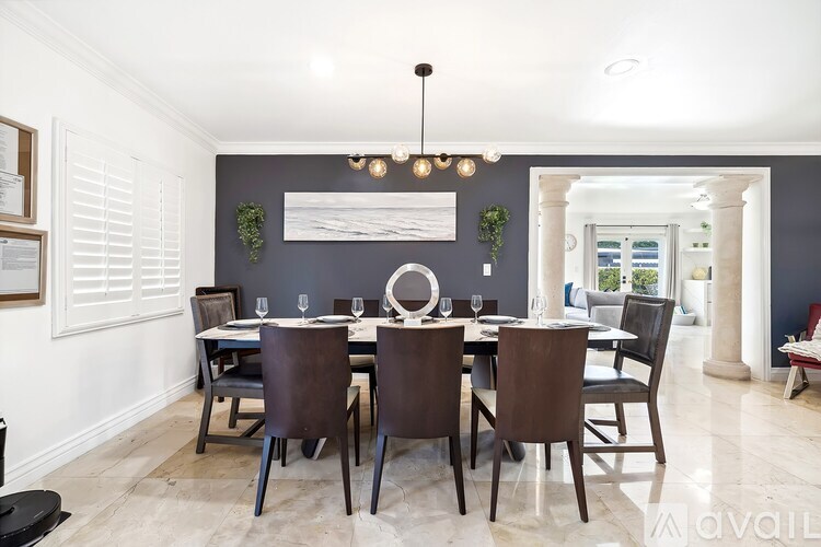 A dining room with a table set for six.