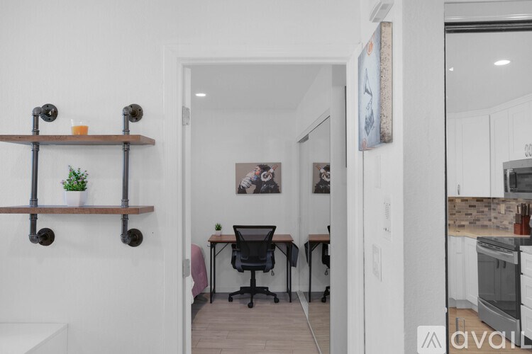 A small room with a desk and a chair.