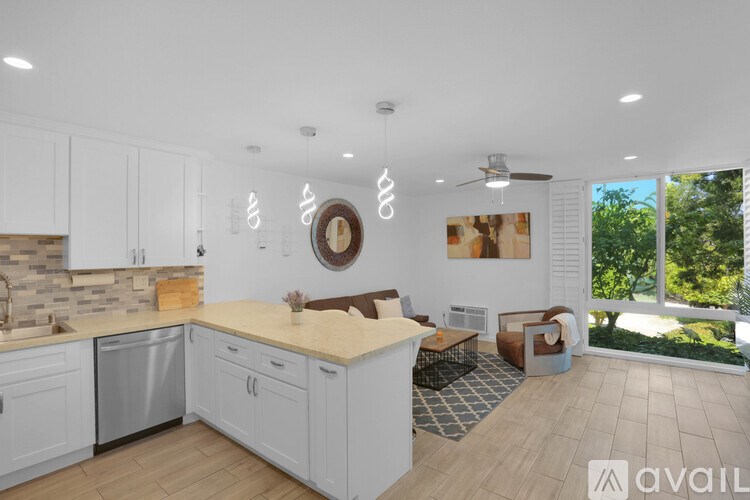 A modern kitchen with white cabinets and a large island.