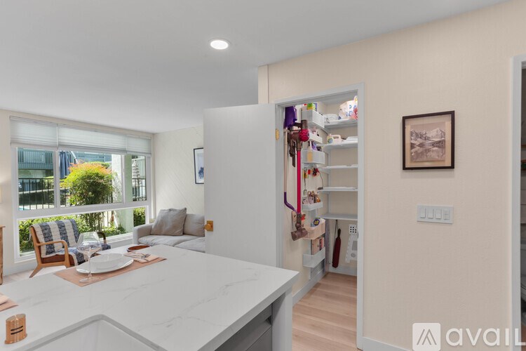 A kitchen with a marble countertop and a dining area with a table and chairs.