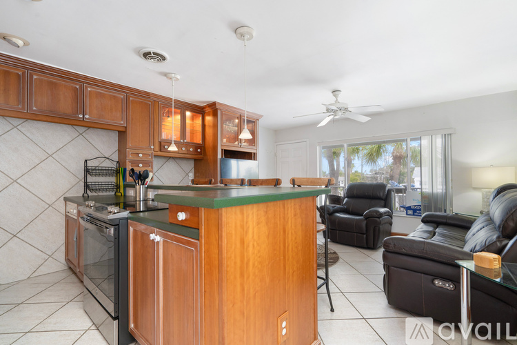 A kitchen with wooden cabinets and a green countertop.