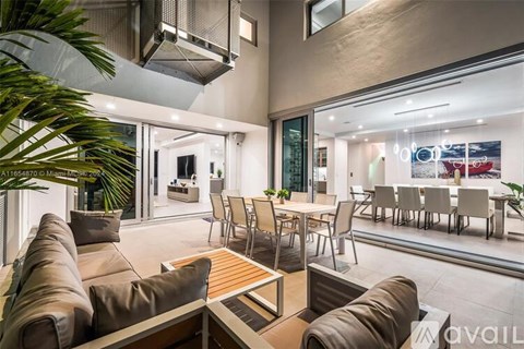 A modern living room with a brown sofa and a wooden coffee table.