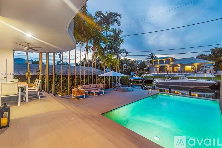 A modern house with a pool and a sunroom.