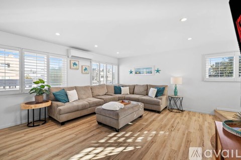 A living room with a large sectional sofa and a coffee table.
