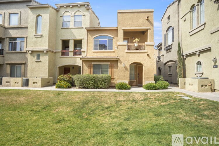 A row of houses with a grassy front yard.