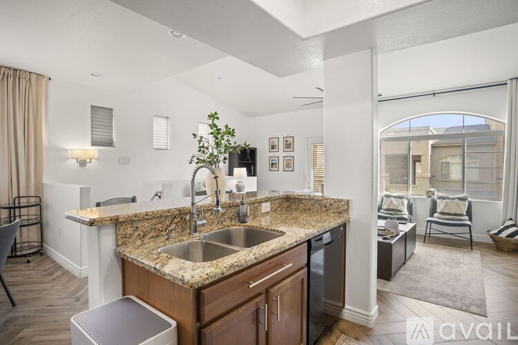 A kitchen with granite countertops and a sink.