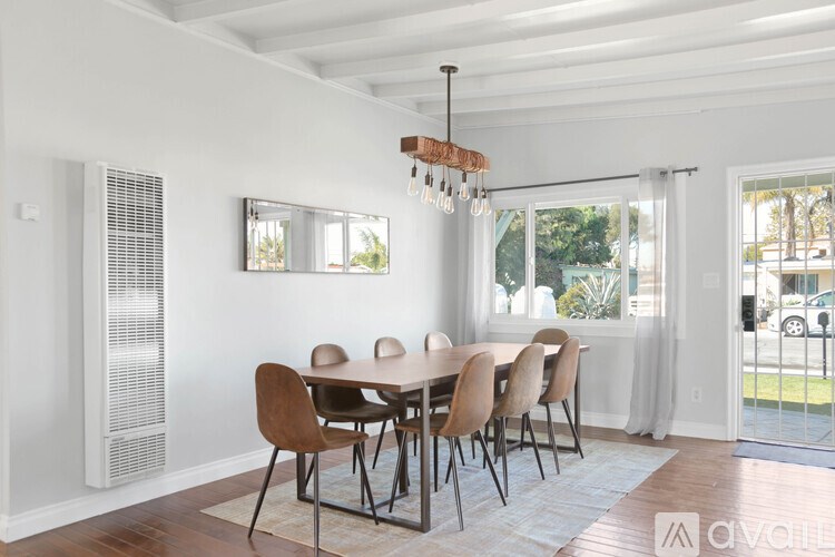A dining room with a table set for six.