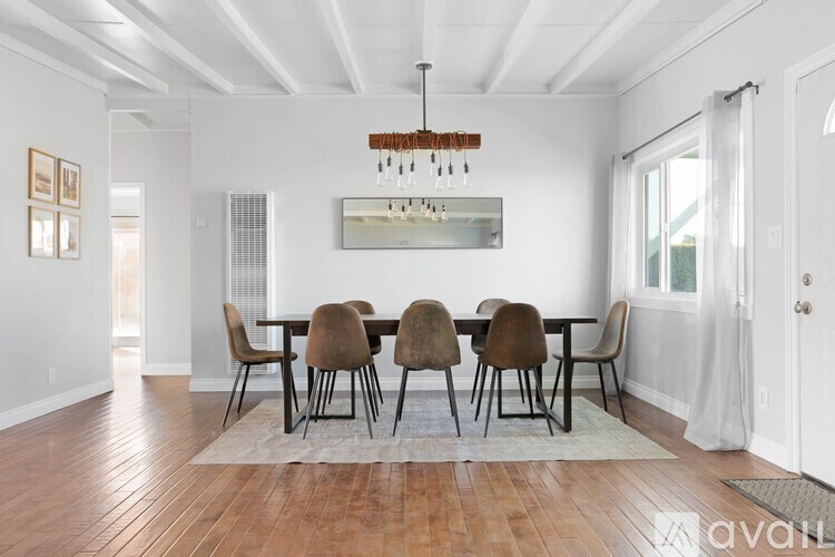 A dining room with a table set for six.