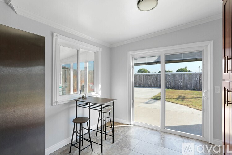 A kitchen with a table and chairs is shown in the image.