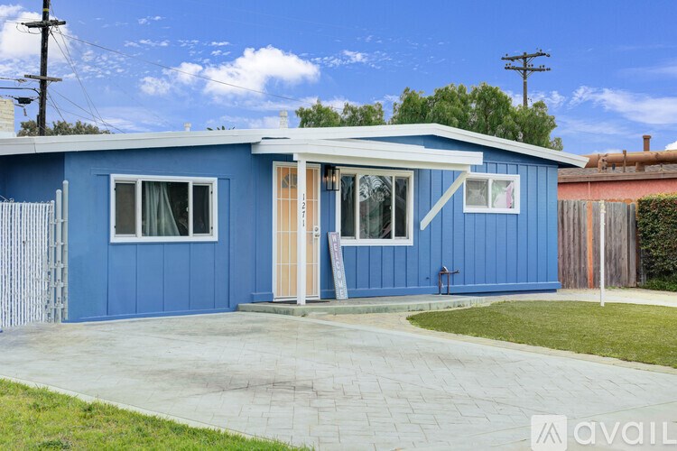 A blue house with a white door and windows.