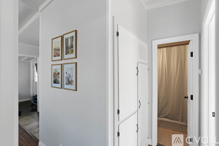 A hallway with a white door and a brown curtain.