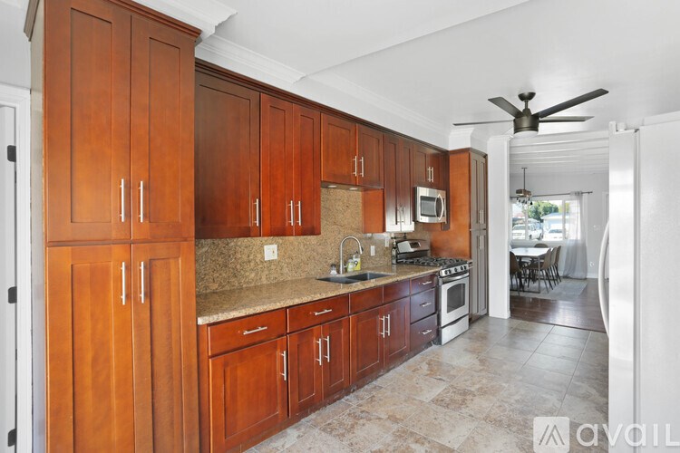A kitchen with wooden cabinets and a white refrigerator.