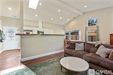 A living room with a brown couch and a coffee table.