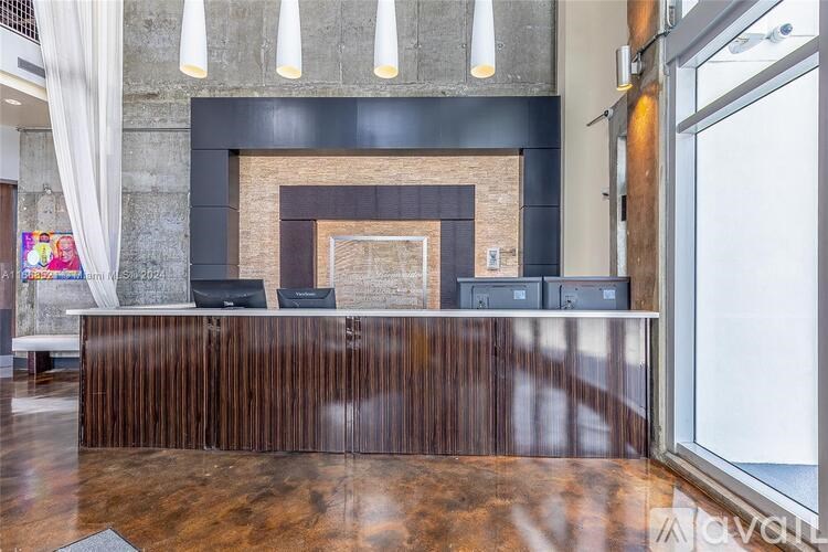 A reception desk with a fireplace in the background.