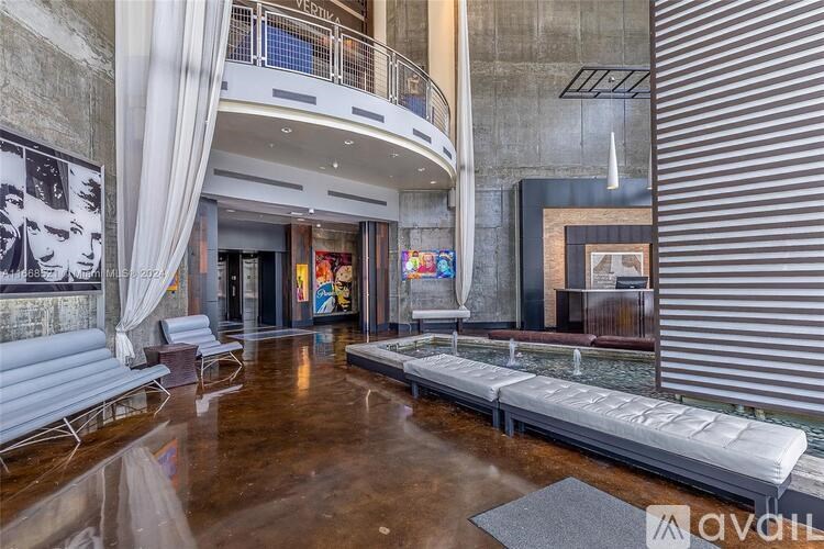 A living room with a white sofa and a wooden floor.