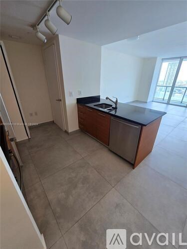 A kitchen area with a counter and a sink.