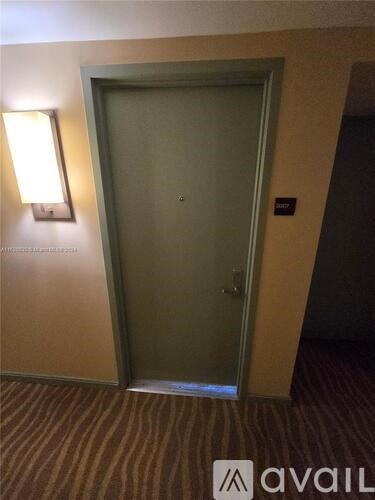 A closed door in a room with Avail sign on the floor.