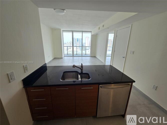 A kitchen with a sink and a window.