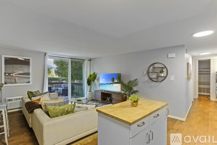 A living room with a couch, a table, and a window.