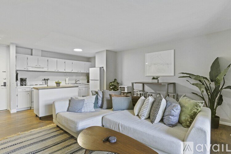 A modern living room with a white sofa and a wooden coffee table.