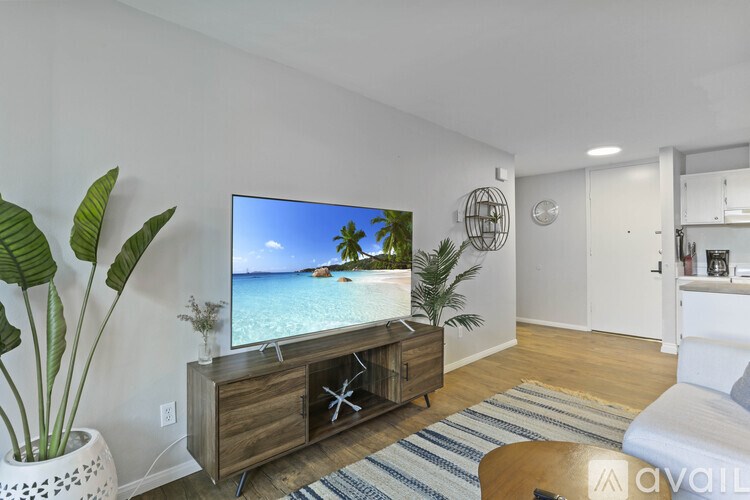 A living room with a television displaying a beach scene.